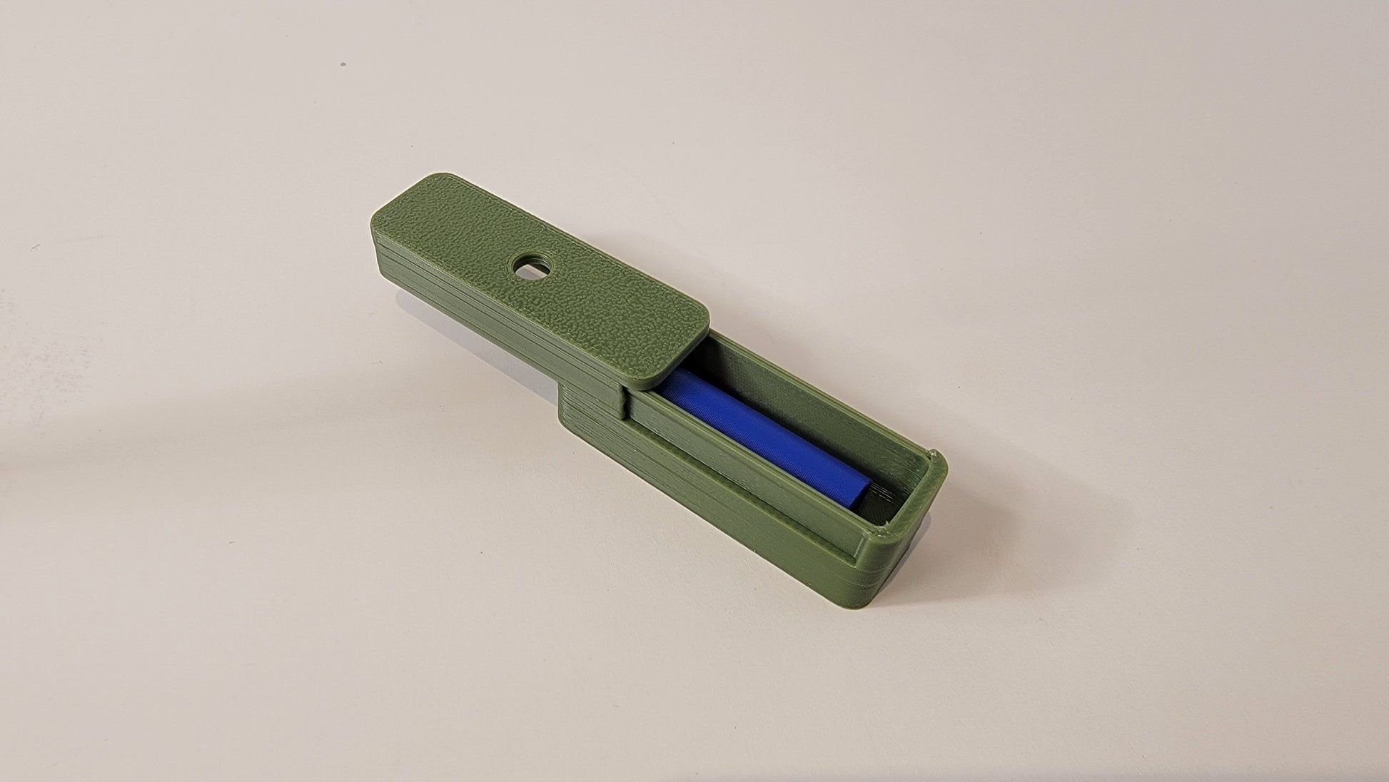 Close-up of magnetic hide opening sized for Q-tips and Getxent tubes