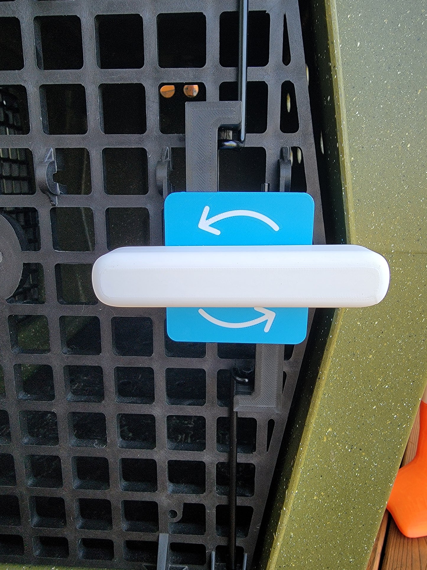 Blue and white turn to open Ruffland Kennel door opener with arrows. Easy install.