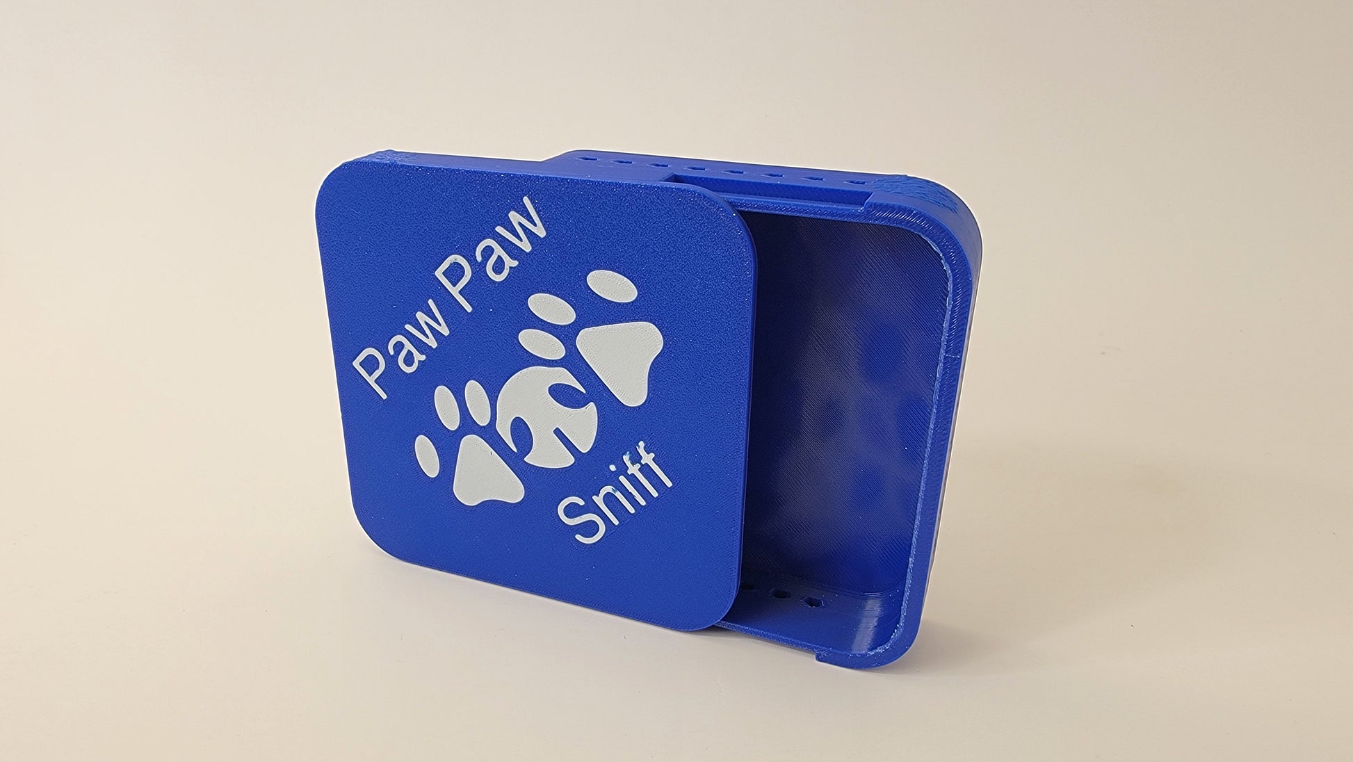 Close-up of tile hide scent opening for nose work odour placement