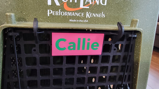 Ruffland kennel name plate snapped onto kennel door